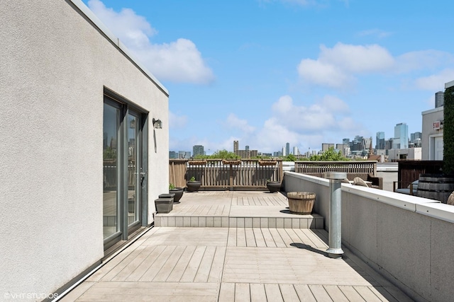 wooden terrace with a view of skyline