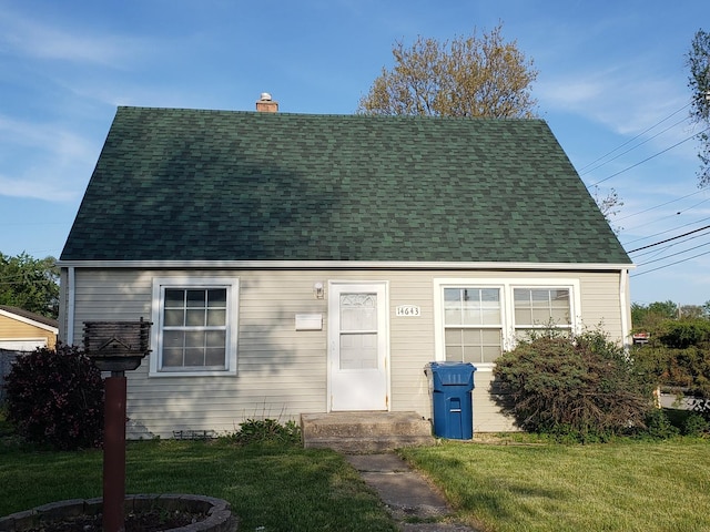 14643 Homan Ave, Midlothian, IL 60445 - cape cod house with a chimney, a front yard, and a shingled roof