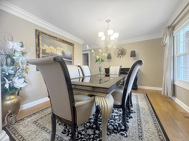 8834 Doubletree Dr N, Crown Point, IN 46307 - dining room with a chandelier, baseboards, crown molding, and light wood-style floors