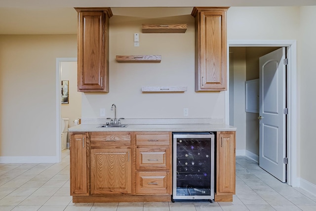 8834 Doubletree Dr N, Crown Point, IN 46307 - indoor wet bar with wine cooler, light tile patterned floors, decorative columns, and baseboards