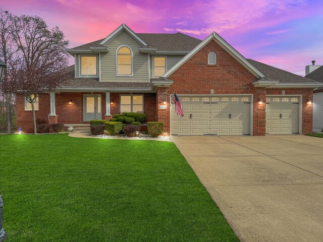 8834 Doubletree Dr N, Crown Point, IN 46307 - traditional home with driveway, a garage, a front yard, a porch, and brick siding