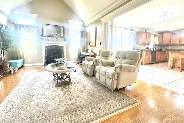 8834 Doubletree Dr N, Crown Point, IN 46307 - living room featuring a tiled fireplace, lofted ceiling, a desk, crown molding, and light wood-type flooring