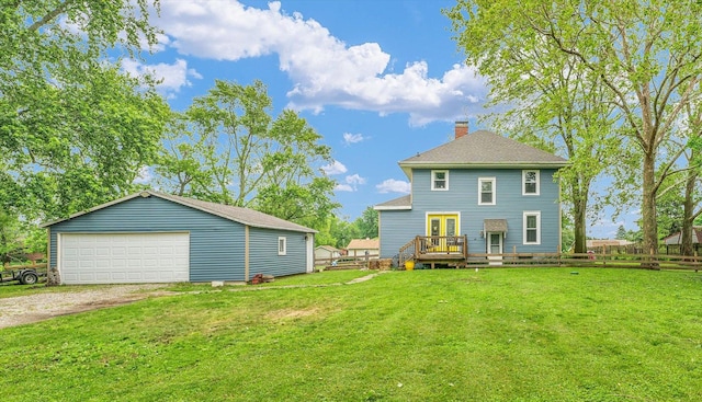 512 S Scarborough St, Sidney, IL 61877 - back of property with a lawn, a garage, a chimney, french doors, and a wooden deck