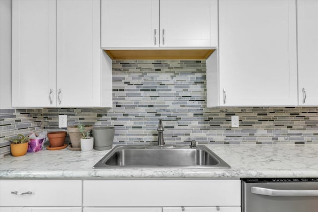 512 S Scarborough St, Sidney, IL 61877 - kitchen with stainless steel dishwasher, a sink, white cabinets, and decorative backsplash