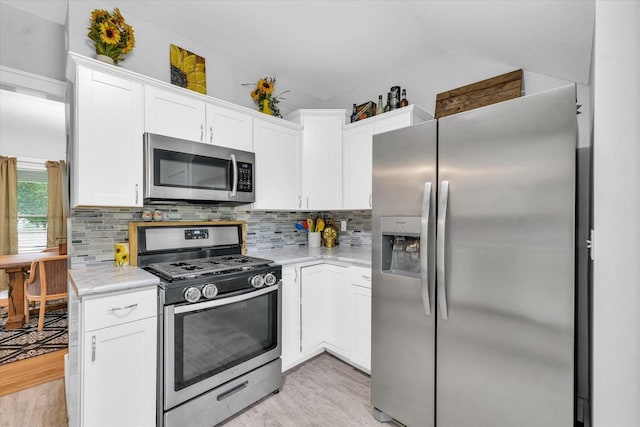 512 S Scarborough St, Sidney, IL 61877 - kitchen with appliances with stainless steel finishes, light wood finished floors, white cabinets, backsplash, and vaulted ceiling