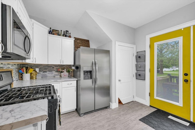512 S Scarborough St, Sidney, IL 61877 - kitchen featuring stainless steel appliances, backsplash, light wood finished floors, white cabinetry, and light stone countertops