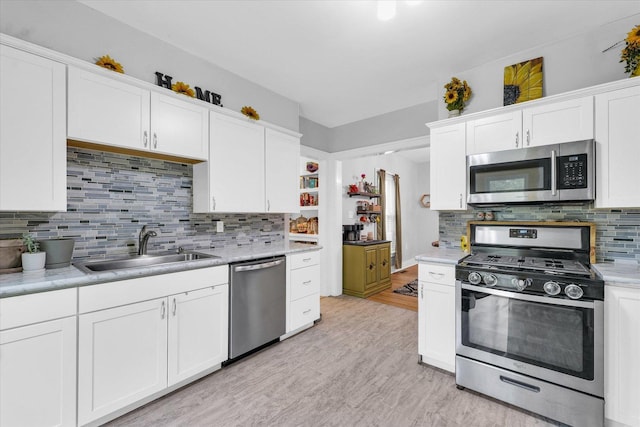 512 S Scarborough St, Sidney, IL 61877 - kitchen with appliances with stainless steel finishes, a sink, white cabinets, and light countertops