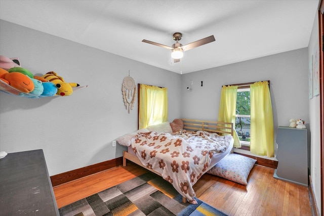512 S Scarborough St, Sidney, IL 61877 - bedroom featuring hardwood / wood-style flooring, baseboards, and a ceiling fan