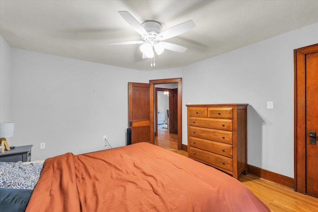 512 S Scarborough St, Sidney, IL 61877 - bedroom with wood finished floors, baseboards, and a ceiling fan