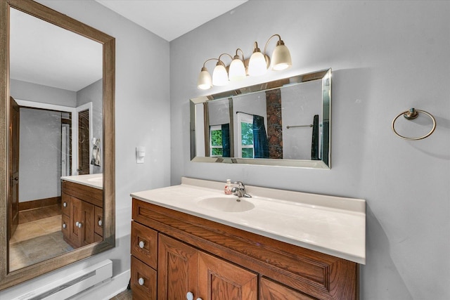 512 S Scarborough St, Sidney, IL 61877 - bathroom featuring a baseboard radiator and vanity