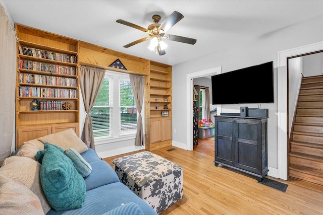 512 S Scarborough St, Sidney, IL 61877 - living room with stairs, ceiling fan, light wood-style flooring, and baseboards