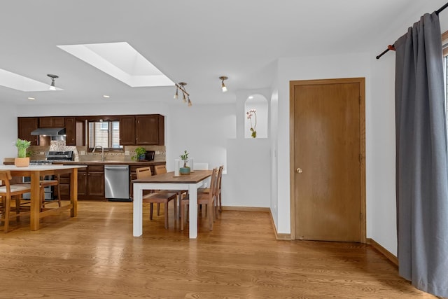 7260 W Fitch Ave, Chicago, IL 60631 - kitchen featuring stainless steel appliances, under cabinet range hood, a skylight, a sink, and light wood finished floors