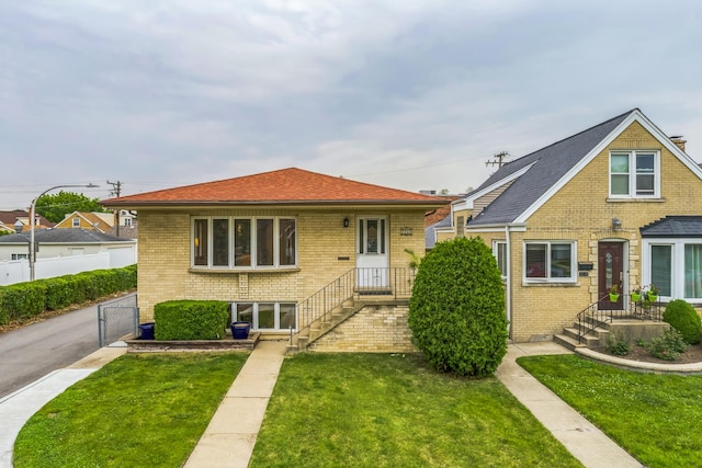 7260 W Fitch Ave, Chicago, IL 60631 - view of front of house with brick siding, a gate, and a shingled roof
