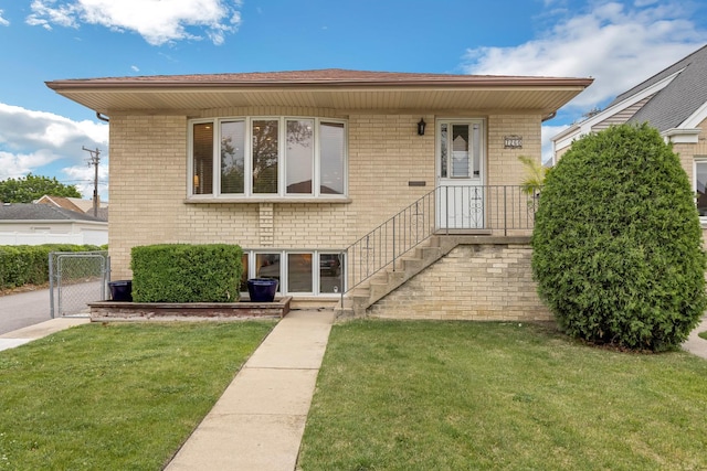 7260 W Fitch Ave, Chicago, IL 60631 - view of front of home with a front yard, brick siding, and a gate