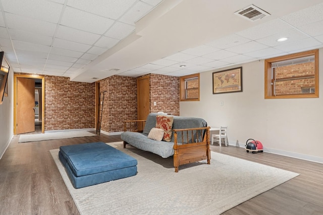 1235 Euclid Ave, Berwyn, IL 60402 - sitting room featuring a paneled ceiling, baseboards, wood finished floors, and brick wall