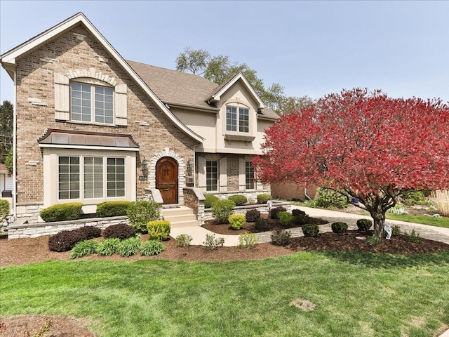 52 Rosemont Ave, Roselle, IL 60172 - view of front of home with a front yard, stucco siding, brick siding, and stone siding