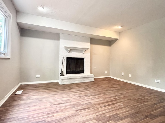 615 N Blanchard St, Wheaton, IL 60187 - unfurnished living room featuring wood finished floors, baseboards, and a fireplace