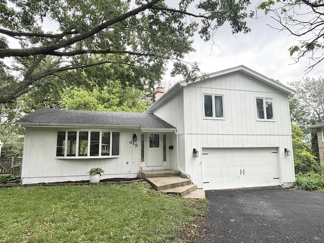 615 N Blanchard St, Wheaton, IL 60187 - tri-level home featuring an attached garage, driveway, a chimney, roof with shingles, and a front yard
