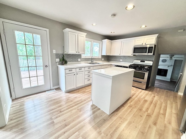 615 N Blanchard St, Wheaton, IL 60187 - kitchen with stainless steel appliances, a sink, white cabinetry, tasteful backsplash, and recessed lighting