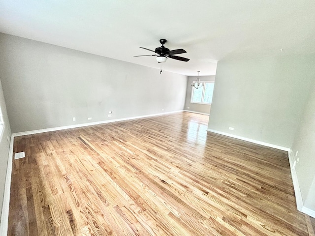 615 N Blanchard St, Wheaton, IL 60187 - spare room with light wood-type flooring, ceiling fan, baseboards, and a chandelier