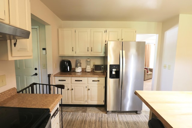 245 N Linn St, Princeton, IL 61356 - kitchen with stainless steel fridge, white cabinets, and under cabinet range hood