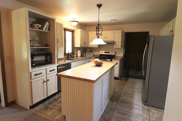 245 N Linn St, Princeton, IL 61356 - kitchen with stainless steel appliances, a sink, wood counters, a center island, and decorative light fixtures