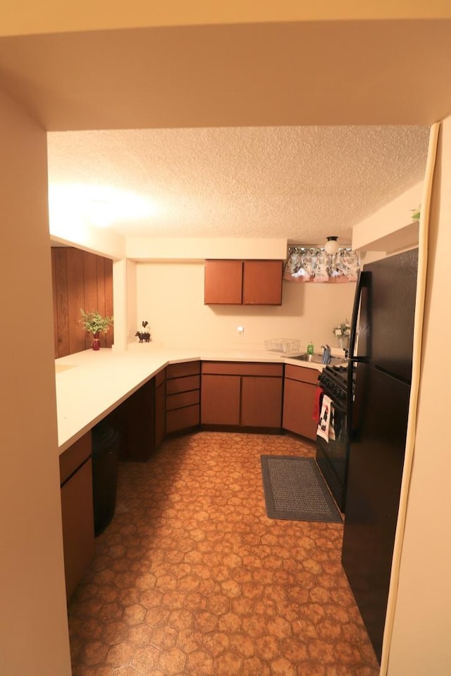 245 N Linn St, Princeton, IL 61356 - kitchen with black appliances, a sink, light countertops, and a textured ceiling