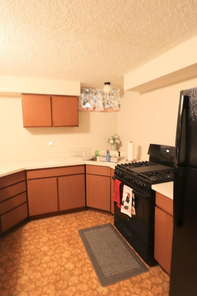 245 N Linn St, Princeton, IL 61356 - kitchen featuring black appliances, light countertops, a textured ceiling, and a sink