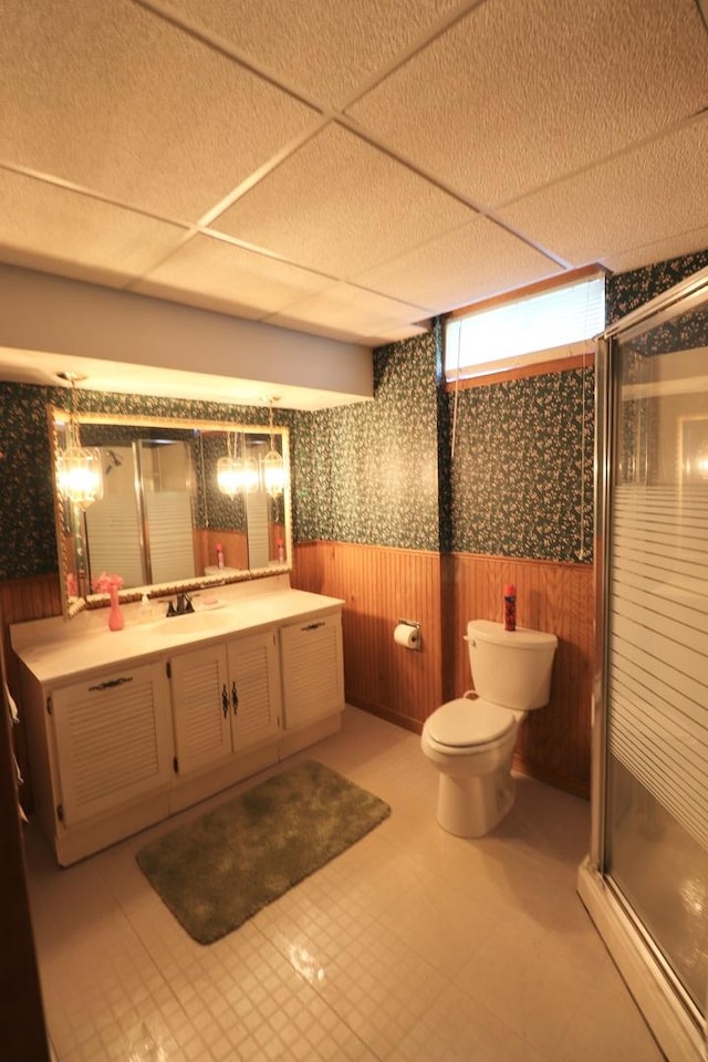 245 N Linn St, Princeton, IL 61356 - full bath with wallpapered walls, wainscoting, a stall shower, toilet, and vanity