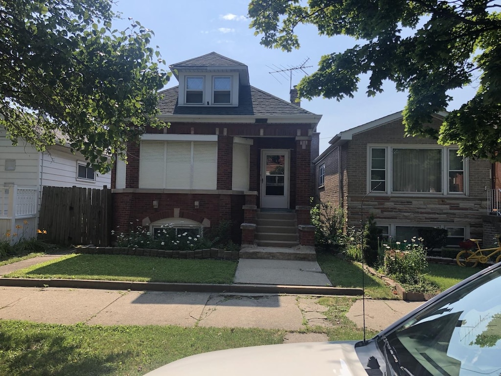 bungalow-style house with brick siding and roof with shingles