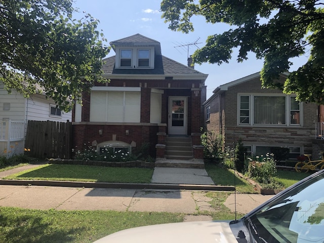 bungalow-style house with brick siding and roof with shingles