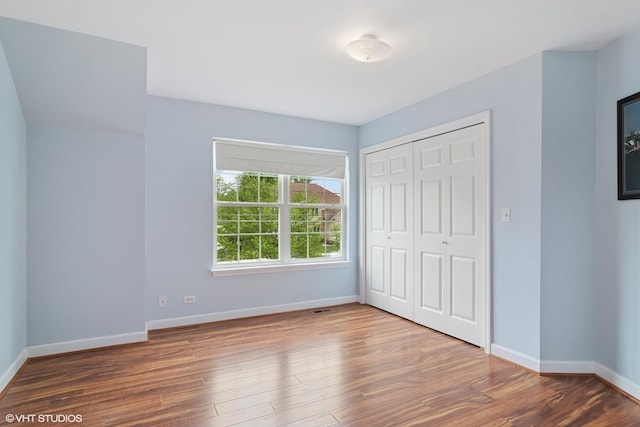 1048 N Palos Ave, Palatine, IL 60067 - unfurnished bedroom with wood finished floors, baseboards, and a closet