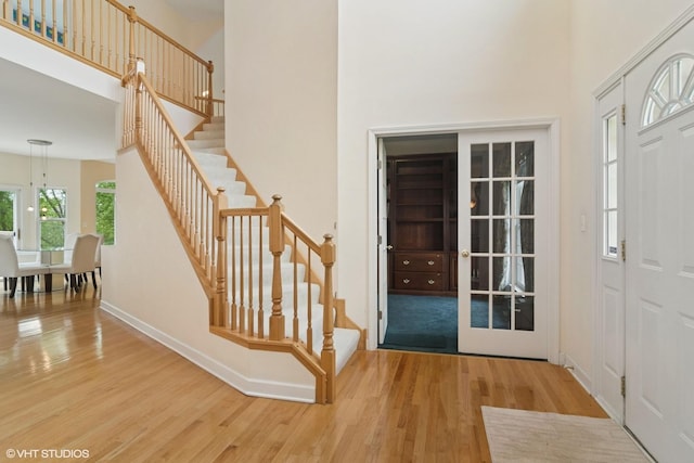1048 N Palos Ave, Palatine, IL 60067 - entryway featuring wood finished floors, stairs, a towering ceiling, and baseboards