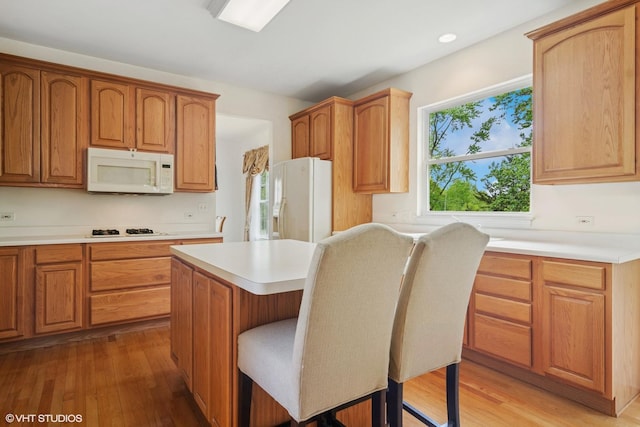 1048 N Palos Ave, Palatine, IL 60067 - kitchen with white appliances, light wood-style floors, light countertops, a kitchen island, and recessed lighting