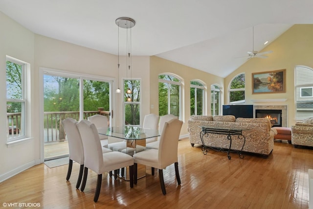 1048 N Palos Ave, Palatine, IL 60067 - dining room with light wood-style floors, ceiling fan, a tile fireplace, baseboards, and vaulted ceiling