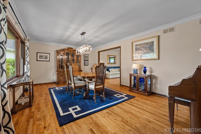 6446 Hanover Ct, Lisle, IL 60532 - dining area featuring a chandelier, light wood-type flooring, plenty of natural light, ornamental molding, and baseboards