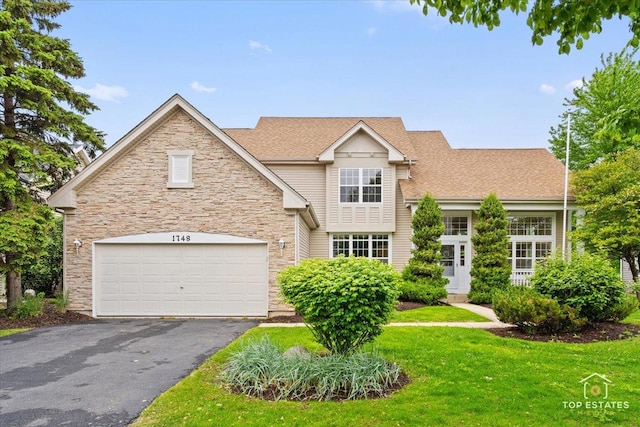1748 Pinnacle Dr, Aurora, IL 60502 - view of front of property featuring driveway, stone siding, a front lawn, a garage, and roof with shingles