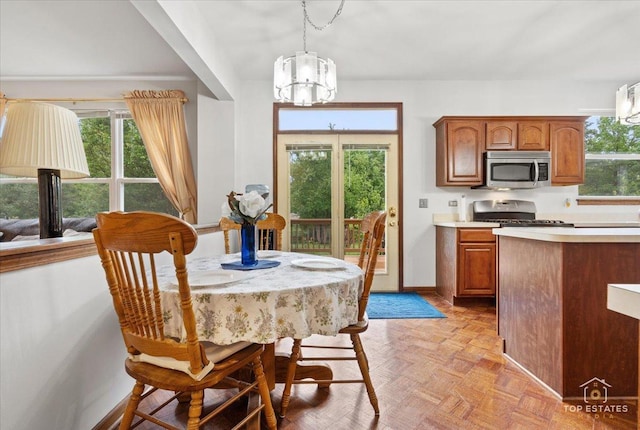 1748 Pinnacle Dr, Aurora, IL 60502 - dining area with a chandelier and baseboards