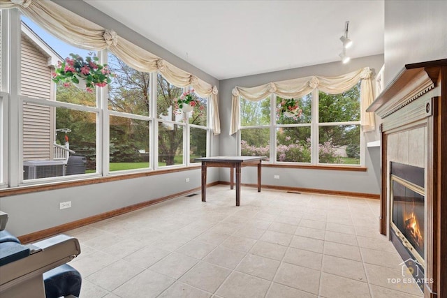 1748 Pinnacle Dr, Aurora, IL 60502 - unfurnished sunroom featuring tile patterned flooring, baseboards, and rail lighting