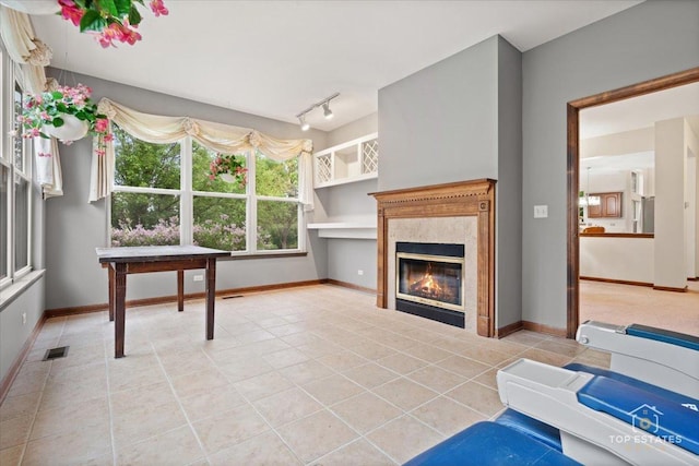 1748 Pinnacle Dr, Aurora, IL 60502 - living room with light tile patterned flooring, a premium fireplace, baseboards, and rail lighting