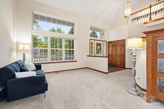 1748 Pinnacle Dr, Aurora, IL 60502 - sitting room featuring carpet flooring, plenty of natural light, baseboards, and high vaulted ceiling