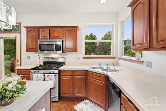 1748 Pinnacle Dr, Aurora, IL 60502 - kitchen with stainless steel appliances, a sink, light countertops, brown cabinetry, and recessed lighting