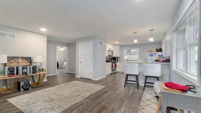 801 Adams St, Oregon, IL 61061 - living room with wood finished floors, baseboards, and recessed lighting