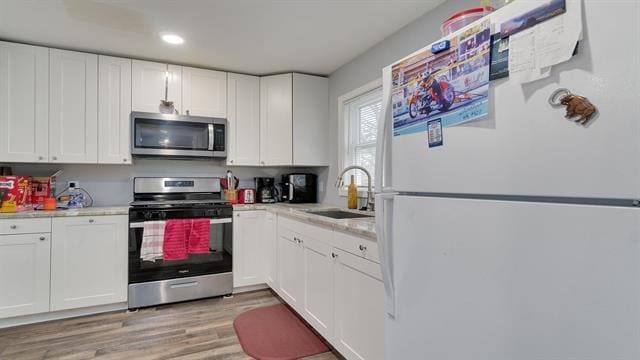 801 Adams St, Oregon, IL 61061 - kitchen with appliances with stainless steel finishes, a sink, light countertops, white cabinets, and recessed lighting