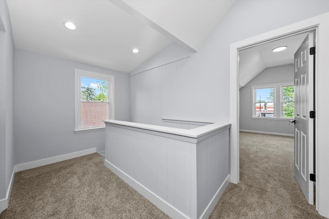 hall with vaulted ceiling, carpet flooring, plenty of natural light, an upstairs landing, and recessed lighting