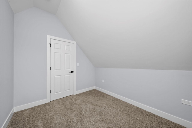 bonus room with vaulted ceiling, carpet flooring, and baseboards