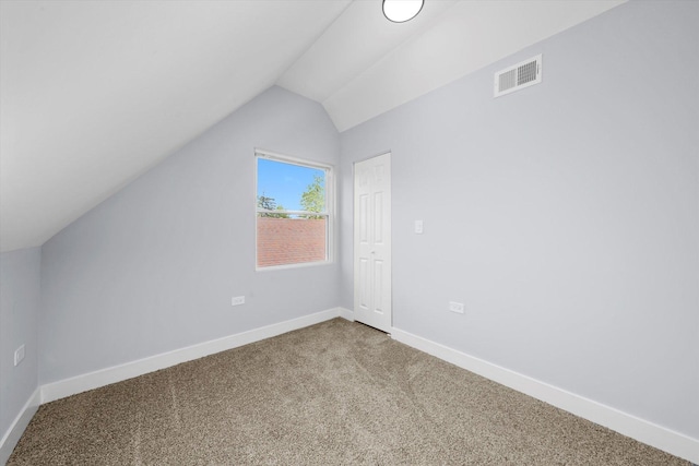 additional living space with vaulted ceiling, carpet, and baseboards