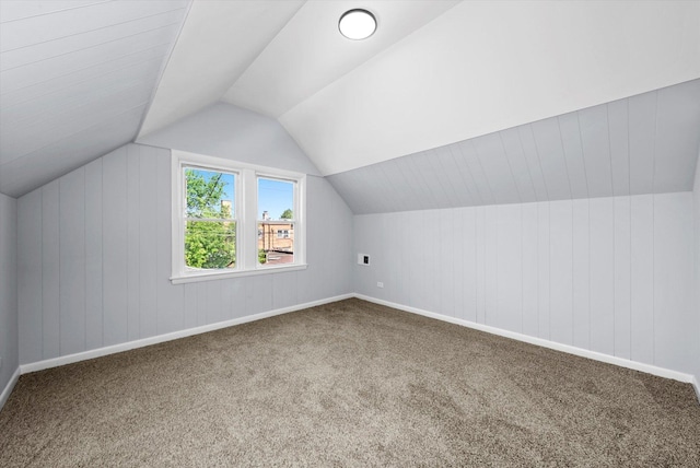 additional living space featuring carpet, lofted ceiling, and baseboards