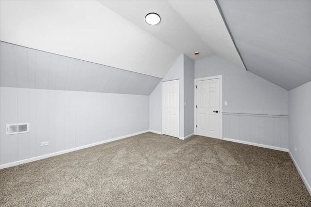 additional living space with carpet and lofted ceiling