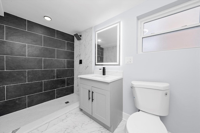 bathroom with marble finish floors, toilet, tiled shower, vanity, and recessed lighting